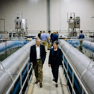 Man and woman walking in fish hatchery