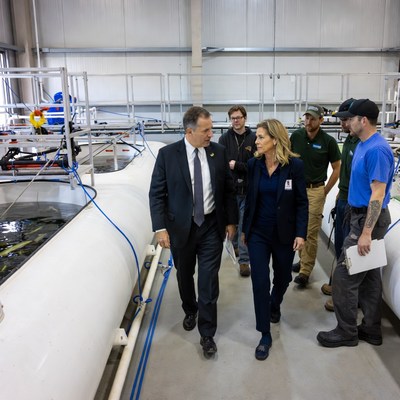 Politician and woman touring fish tanks