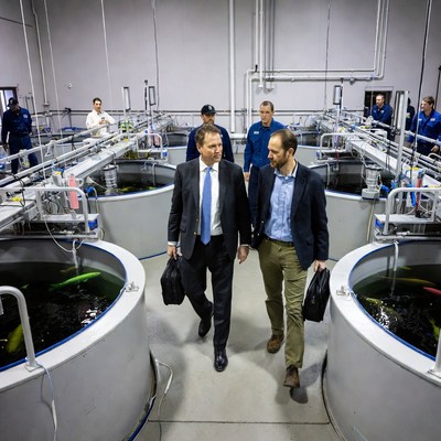 Men touring fish farm tanks