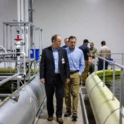 Men touring industrial fish farm