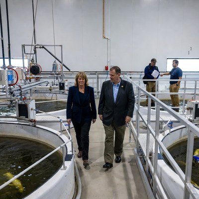 Man and woman walking in fish farm