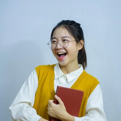 Asian girl smiling with book