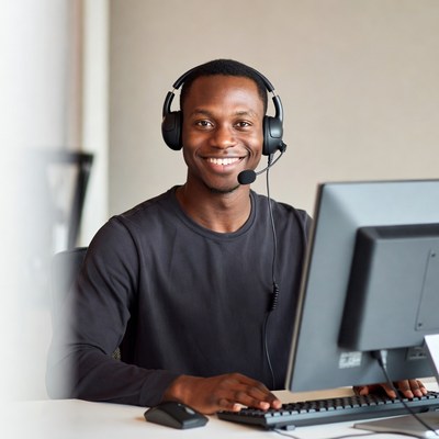 African-American man wearing headset at computer