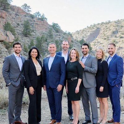 Business team posing in rocky mountains