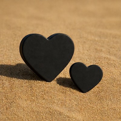 Black hearts on sand