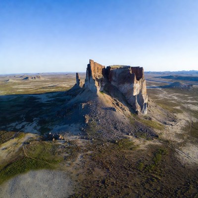 Towering Rock Formation in Desert Landscape