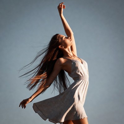 Woman dancing with arms raised