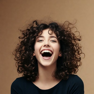 Young woman laughing with curly hair