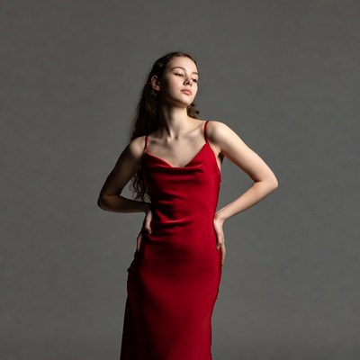 Young woman in red slip dress