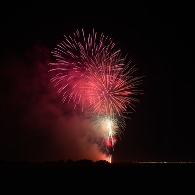 Red Fireworks Exploding at Night