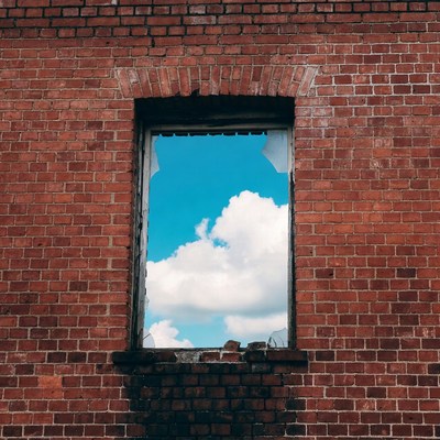 Broken Window in Red Brick Wall