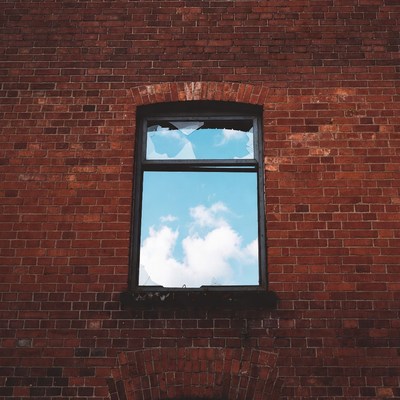 Broken Window in Red Brick Wall