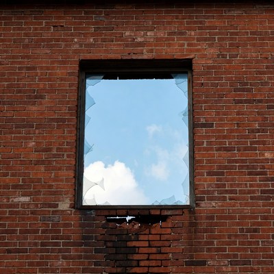 Broken Window in Red Brick Wall