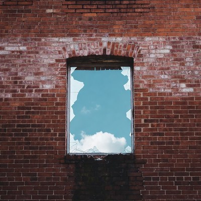 Broken Window in Red Brick Wall