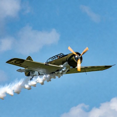WWII Fighter Plane Flying with Smoke Trail
