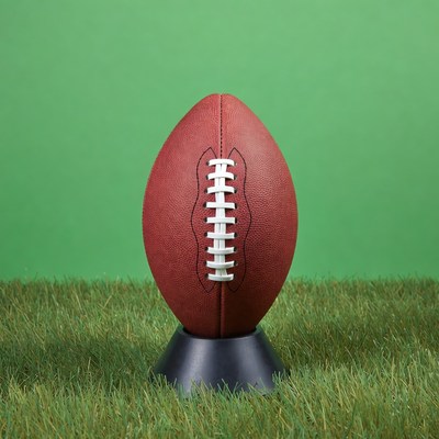 Football on green field stand