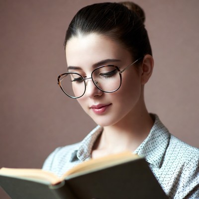 Woman reading book in glasses