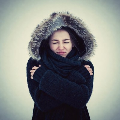 Woman shivering in fur hood winter coat