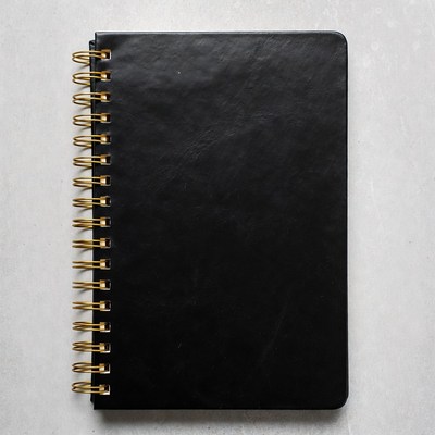 Black Spiral Notebook on White Surface