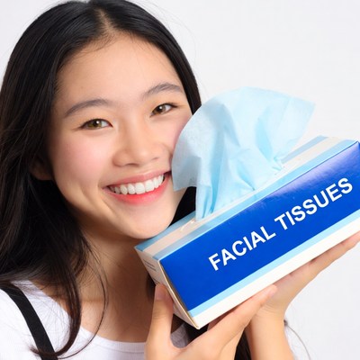 Asian woman holding facial tissues
