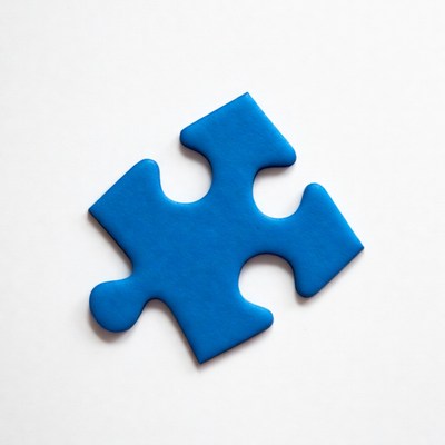 Blue puzzle piece on white