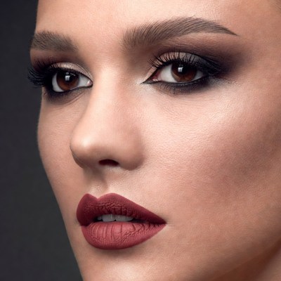 Woman with dramatic smoky eyes and matte lips