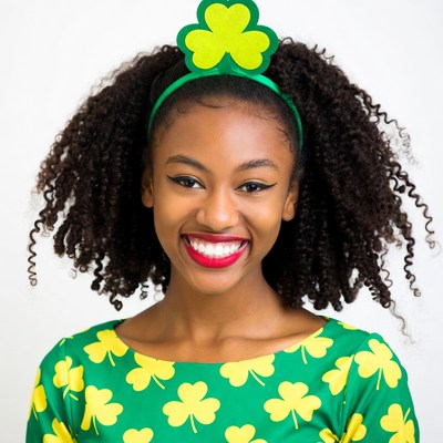 African-American woman smiling in shamrock dress