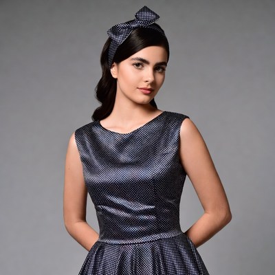 Woman in polka dot dress with bow headband