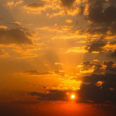 Vibrant Sunset Sun with Orange Clouds