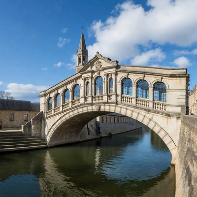 Stone Bridge over River with Church Spire