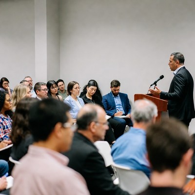 Man speaking at business conference podium
