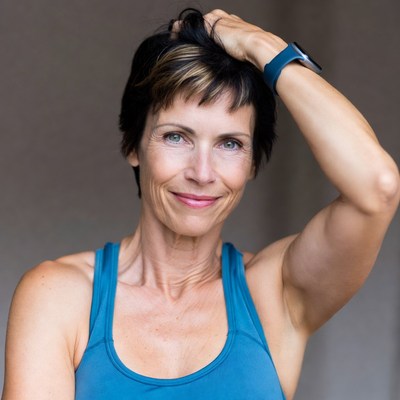 Smiling woman with hand in short hair