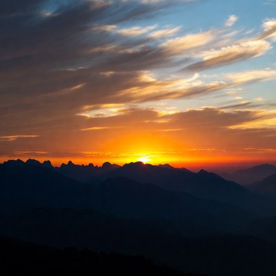 Sunset over silhouetted mountains