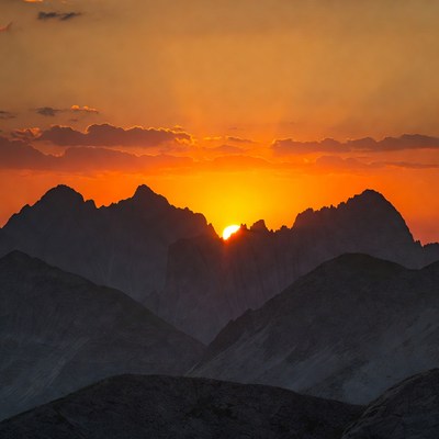 Sunset Behind Jagged Mountains