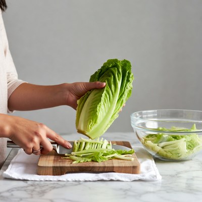 Asian woman chopping cabbage