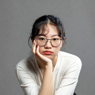 Asian girl with glasses hand on chin