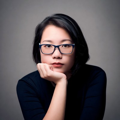 Asian woman resting chin on hand