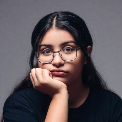 Latina woman resting chin on hand