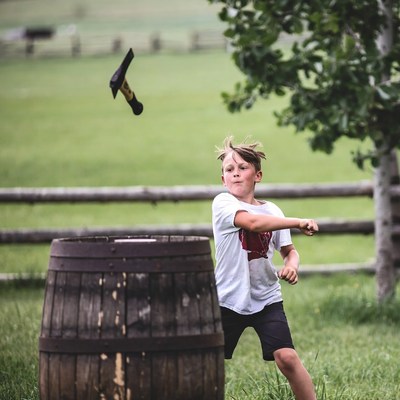 Boy throwing horseshoe at stake