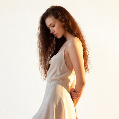 Woman in white slip dress side profile