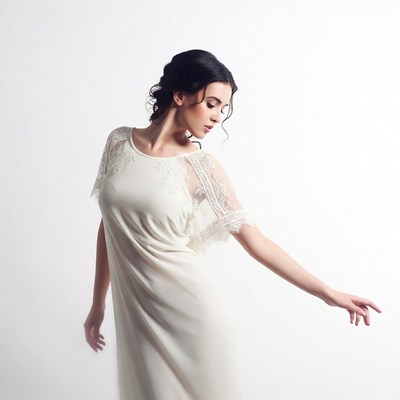 Woman in lace sleeve dress posing