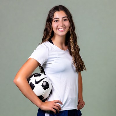 Smiling girl holding soccer ball