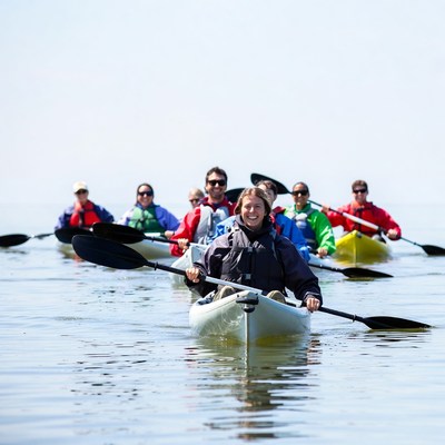 Group kayaking on calm water