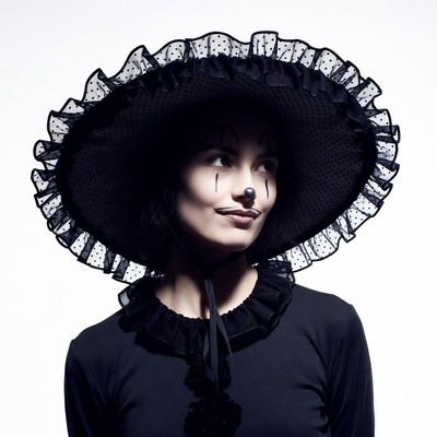 Woman in black lace hat with clown makeup