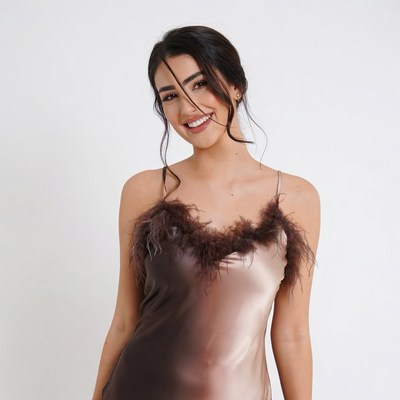 Smiling woman in feathered satin dress