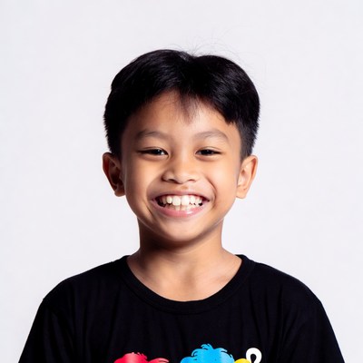 Asian boy smiling in black t-shirt
