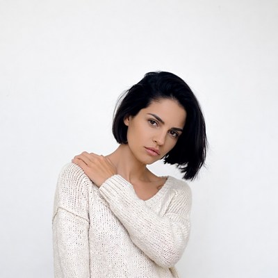 Woman hand on shoulder white sweater