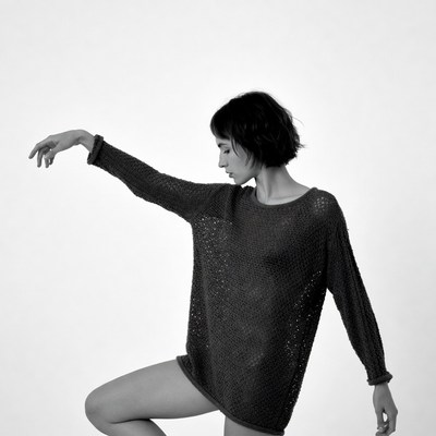 Woman dancing in knit sweater
