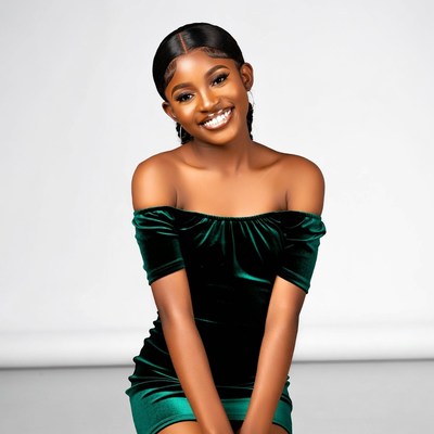 Smiling Black woman in green velvet dress