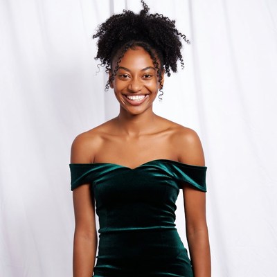 Smiling African-American woman in green velvet dress